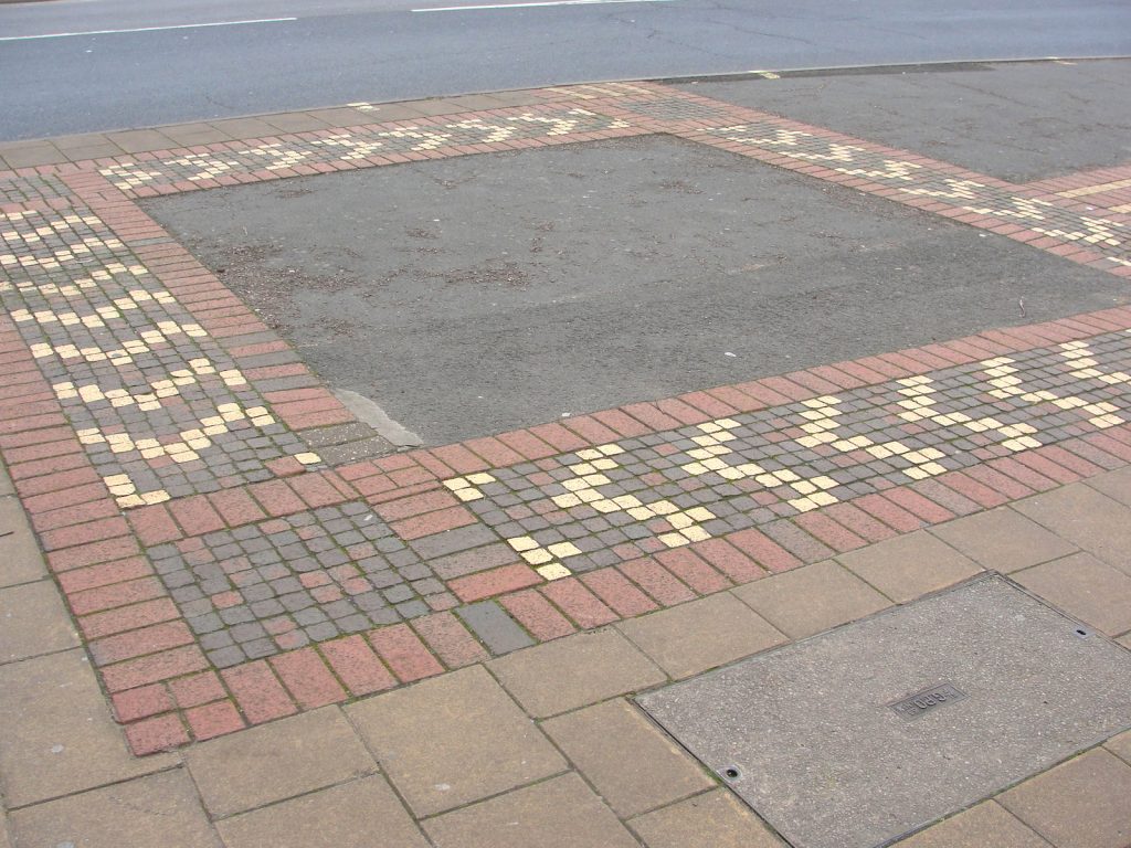 The South Gate of the walls of Exeter, Devon. Outline marked in pavement.